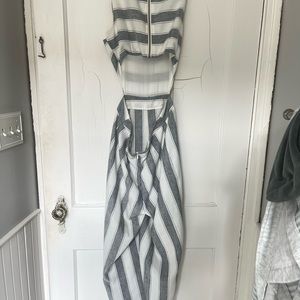 Grey and white jumpsuit with open back. Capri length